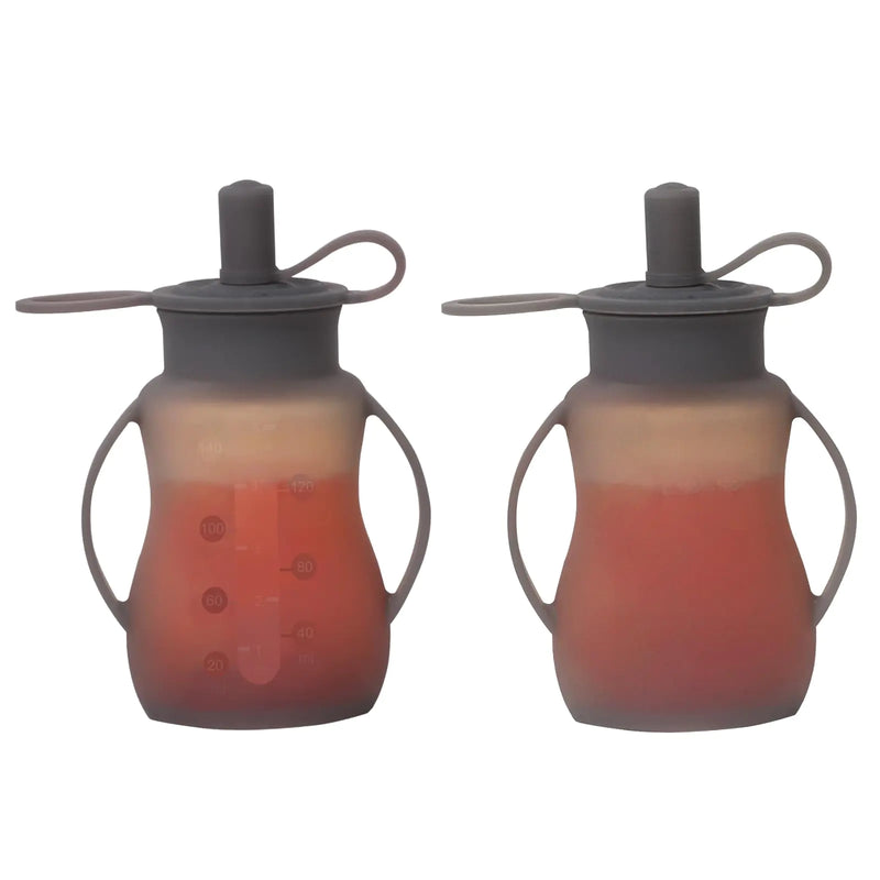 Two silicone reusable baby food pouches with gray lids on a white background