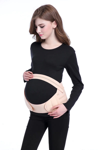 Woman wearing a beige maternity belt on a white background