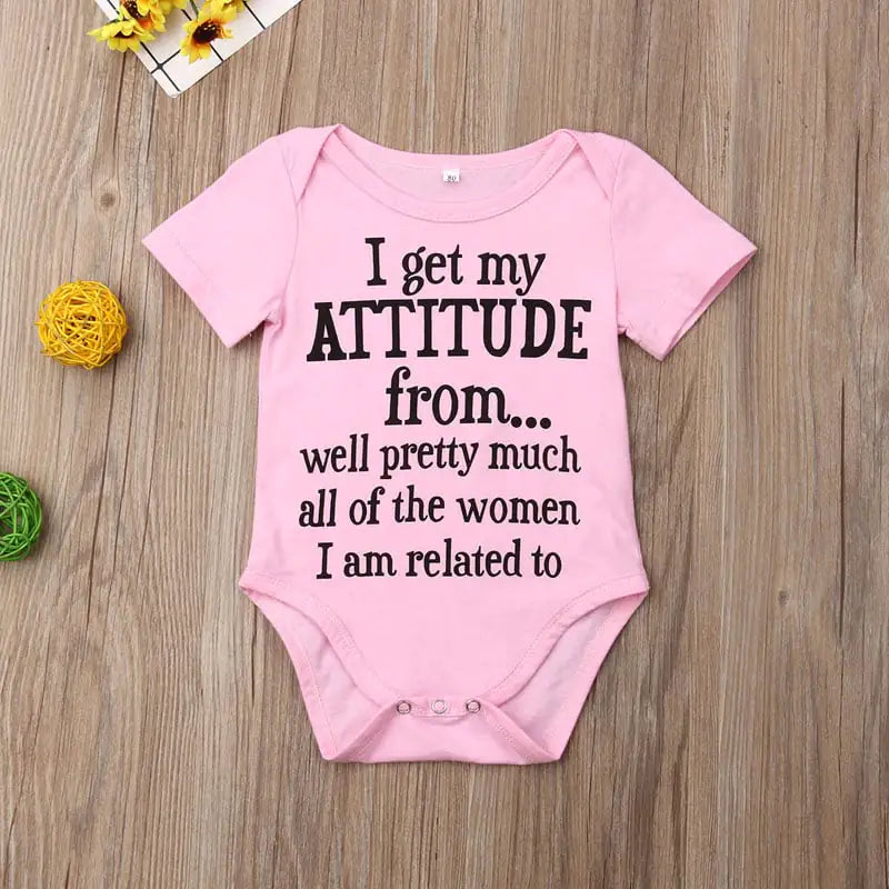 Pink baby onesie with humorous text that says I get my ATTITUDE from....well pretty much all of the women I am related to