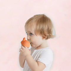 Cute silicone baby teether being gnawed on by a toddler