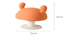 Cute silicone baby teether on a beige background