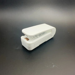 White stapler on a dark gray background