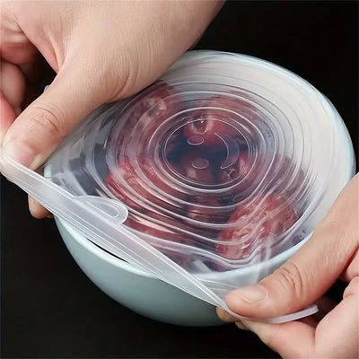 Person holding a silicone lid over a container with food inside