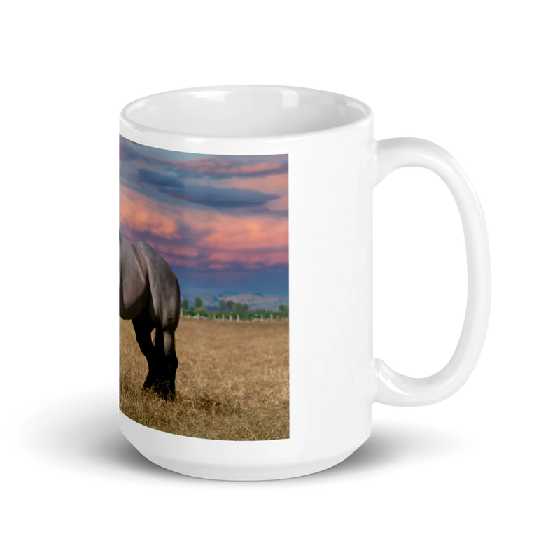 White mug with a horse in a field design on a white background