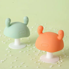 Two Cute silicone baby teethers on a beige background
