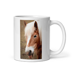White mug with a horse's face printed on it sticking out its tongue