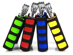 Four hand grip trainers leaning against each other in green, red, bue and yellow